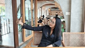 A long-haired woman selfie with smart phone in cafe. - Powered by Shutterstock - Get 15% off with code: PIKWIZARD15