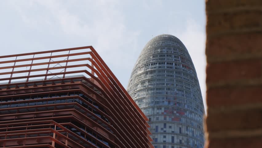 Modern glass office scyscraper buildings beautifully reflecting the clear blue sky in an urban environment