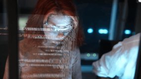 female programmer wearing glasses is coding a hologram at night, working on data analytics, information technology, or software at the office. A futuristic technology solution for business development - Powered by Shutterstock - Get 15% off with code: PIKWIZARD15