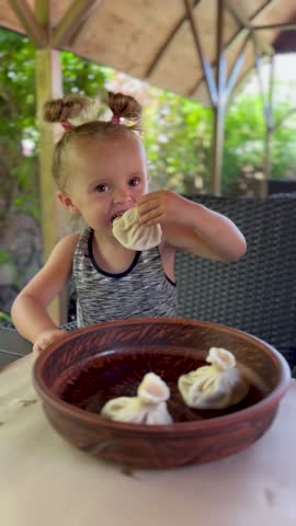 Little girl enjoys Georgian cuisine in a cafe. Perfect shot for tourism, family vacation ads and travel agencies