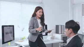 Young asian businesswoman presenting sales data to businessman in modern office, discussing new project strategy, collaborating and analyzing financial statistics on tablet computer - Powered by Shutterstock - Get 15% off with code: PIKWIZARD15