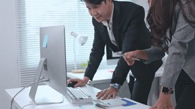 Two business colleagues are examining financial data displayed on a computer screen, actively discussing and pointing at specific figures on printed reports - Powered by Shutterstock - Get 15% off with code: PIKWIZARD15