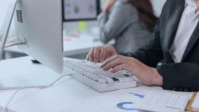 Professional businessman analyzing financial charts, typing on keyboard while working at modern office desk, engaging with digital technology and business data - Powered by Shutterstock - Get 15% off with code: PIKWIZARD15