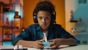 African American boy playing online video game with gamepad, fun hobby - Powered by Shutterstock - Get 15% off with code: PIKWIZARD15