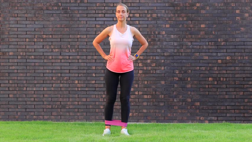 Woman exercising with resistance band outdoors