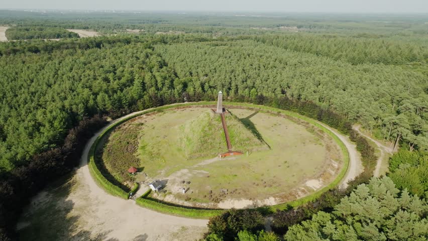 Aerial view of pyramid Austerlitz monument with obelisk, circular path and forest landscape in summer sunlight