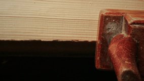 Close up view of hand of carpenter using handheld planer to polish wooden plank, producing curled wood shavings during woodworking process - Powered by Shutterstock - Get 15% off with code: PIKWIZARD15