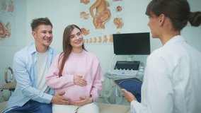Smiling Caucasian couple expecting baby and sitting together in gynecology office. Listening carefully to consultation. Man touching pregnant belly while doctor with tablet talking to them. - Powered by Shutterstock - Get 15% off with code: PIKWIZARD15