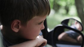 A portrait of a child peeking out from a car window. - Powered by Shutterstock - Get 15% off with code: PIKWIZARD15