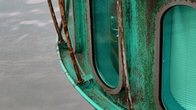 Detailed view of vintage green submarine gondola with weathered turquoise patina, rust stains, oval windows above Baltic Sea water. Tourist attraction in Sellin, Germany. - Powered by Shutterstock - Get 15% off with code: PIKWIZARD15
