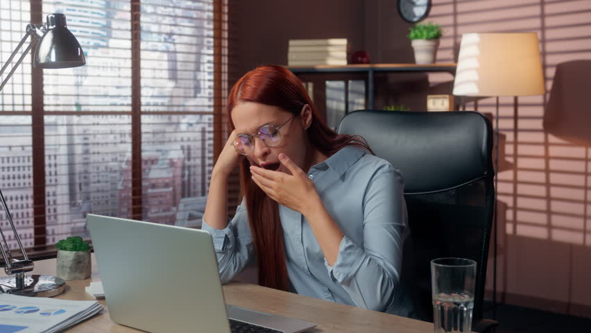 Alone tired sleepy businesswoman yawning in office Caucasian business woman working with laptop girl female online compnay job yawn low energy insomnia health problem burnout bored exhausted overwork