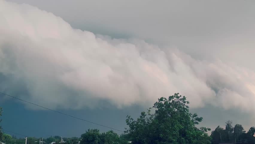 Giant thundercloud with lightning moving across the sky