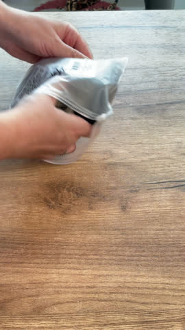 Woman reviews womens stockings. Lays them out on the table. Vertical video. Close-up