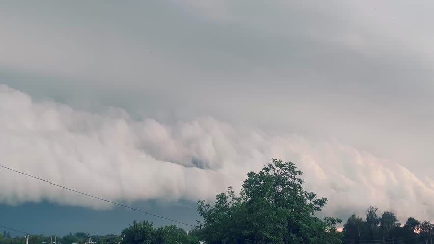 Giant thundercloud with lightning moving across the sky