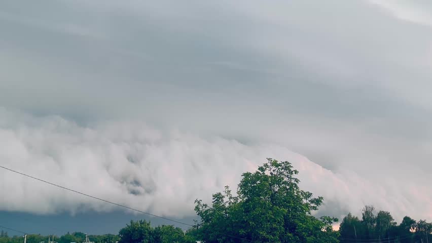 Giant thundercloud with lightning moving across the sky