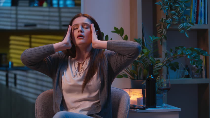 Stressed woman alone at night headache panic attack anxiety breathing meditation close eyes stress relief Caucasian girl female at home evening feel calm tranquil relax meditate health mind practice
