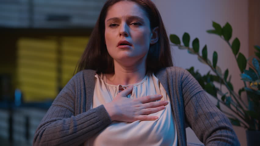 Stressed woman heart attack pain in chest sick Caucasian girl at night home evening health problem ache emergency medicine help heartache hurt in breast symptom pressure cardio unwell female scared