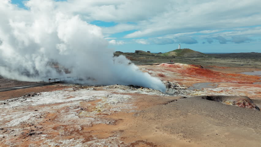 Geothermal steam plume in Gunnuhver geothermal field Reykjanes Peninsula. 4K aerial video showcasing geothermal power across vibrant volcanic soil.