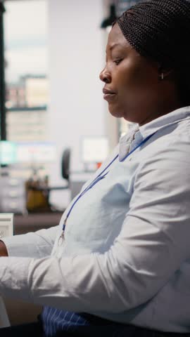 Engineer in office develops innovative solar powered device using advanced materials and designs. RD department expert creating solar gadget to improve environmental conservation efficiency, camera B