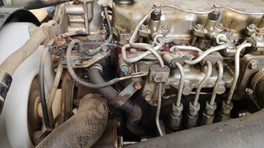 A detailed view of a diesel car engine, focusing on the fuel line system, connectors, and hoses, showcasing the complexity of its mechanical components.