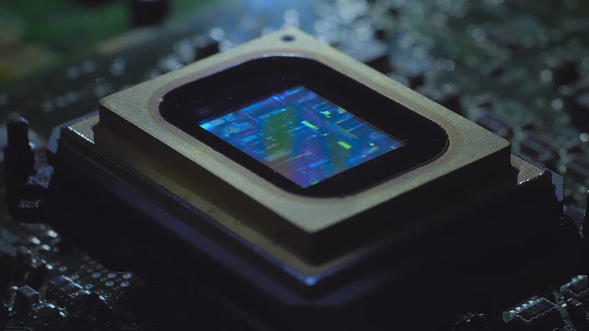 A video matrix located on the printed circuit board plays a clip about the structure of a microcircuit inside, filmed through a microscope. Closeup. Macro. Shallow depth of field 
