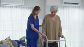 Asian senior older woman patient doing physical therapy with caregiver. Attractive specialist carer help and support elderly mature grandma practice walking slowly with walker at nursing home care. - Powered by Shutterstock - Get 15% off with code: PIKWIZARD15