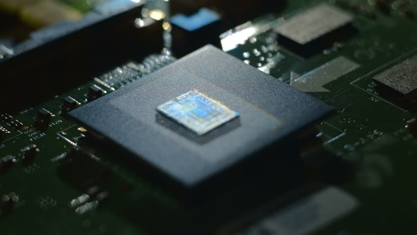 Lines of program code moves on a processor in a circuit board, symbolizing the operation of an electronic device. Closeup. Macro. Follow focus. Shallow depth of field - Powered by Shutterstock - Get 15% off with code: PIKWIZARD15