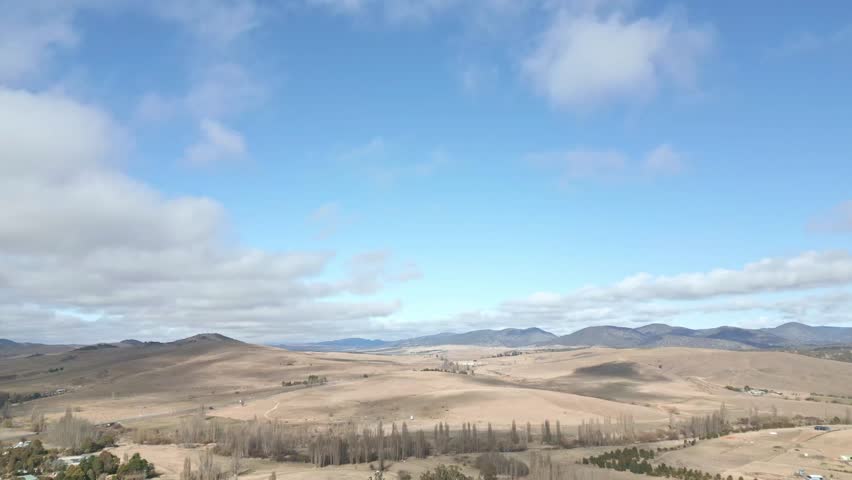 Australian country side with dry rolling hills and big sky.