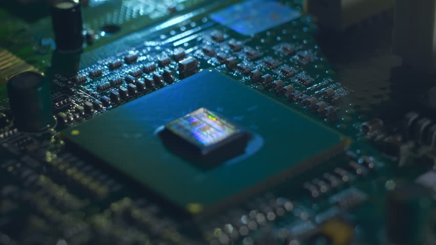 Lines of program code moves on a processor in a circuit board, symbolizing the operation of an electronic device. Closeup. Macro. Follow focus. Shallow depth of field - Powered by Shutterstock - Get 15% off with code: PIKWIZARD15