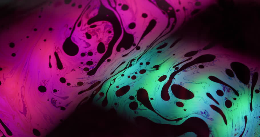 Paint mix. Neon fluid flow. Pink blue green oil liquid swirl on black water. Blur abstract bright color glow fizz whirl background.