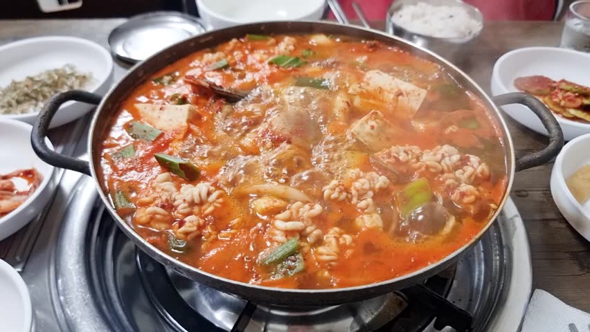 Spicy Korean fish stew maeuntang and pollock soup dongtae tang with vegetables tofu red pepper broth fish roe and goni milt served as traditional seafood dish