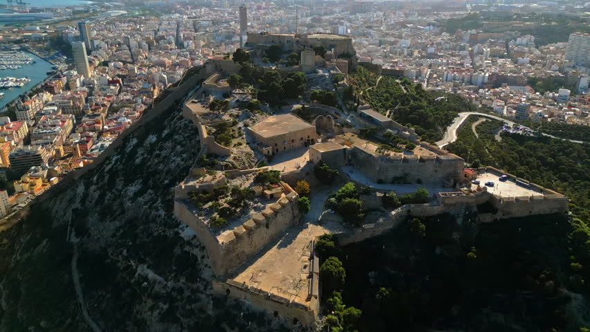 Aerial drone view of the Santa Barbara Castle on the coast of Alicante, Spain with the city and the sea on the background