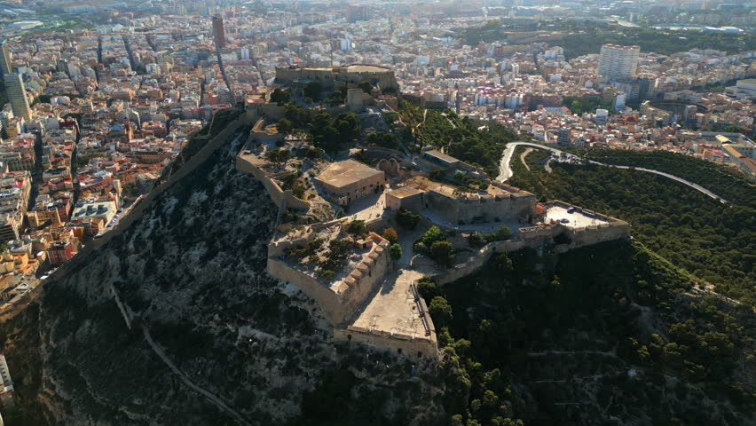 Aerial drone view of the Santa Barbara Castle on the coast of Alicante, Spain with the city on the background
