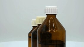 Three amber bottles arranged neatly against a plain backdrop showcase their unique shapes and colors. The focus is on their design and potential uses in arts and crafts. - Powered by Shutterstock - Get 15% off with code: PIKWIZARD15