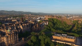 Aerial footage of Edinburgh at sunrise as the city wakes under soft golden light, revealing rooftops, landmarks, and peaceful streets - Powered by Shutterstock - Get 15% off with code: PIKWIZARD15
