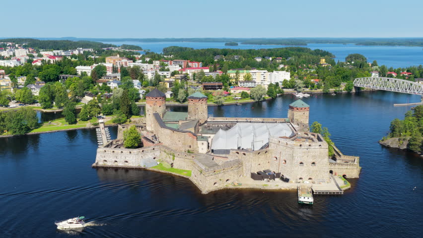 Panoramic drone shot around the Olafsborg Castle, sunny, summer day in Finland