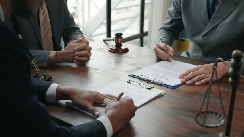 Negotiation meeting among legal professionals office setting business discussion indoor environment close-up view