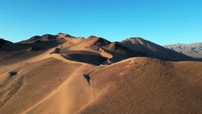 Aerial drone shot of Medanoso sand dune in the Chilean Atacama Desert glowing under golden sunset light. - Powered by Shutterstock - Get 15% off with code: PIKWIZARD15