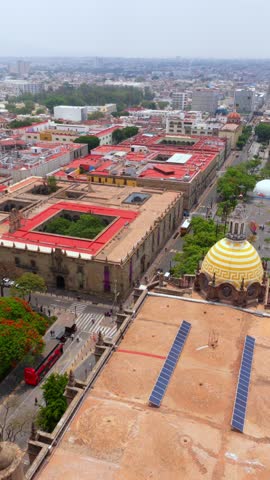 Vertical aerial of Guadalajara Cathedral rooftop and dome, Plaza de la Liberación and Teatro Degollado in Guadalajara, Mexico
