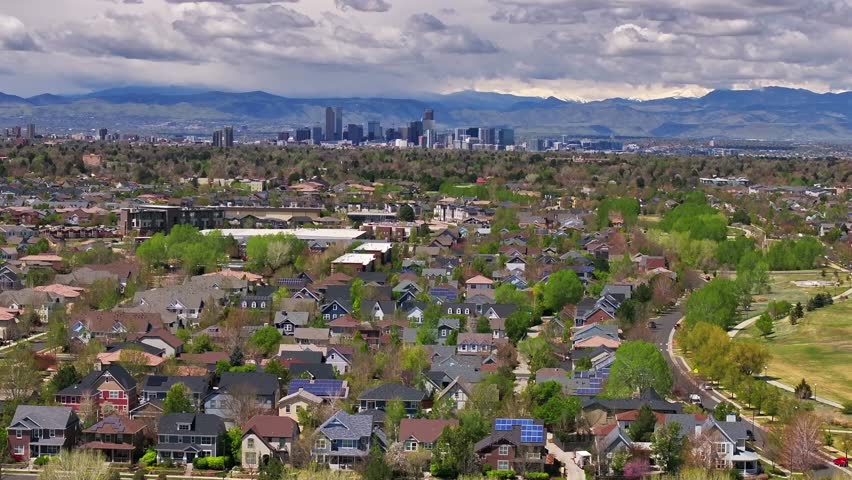 Front Range Denver Lowry Northfield Central Park Colorado aerial drone summer spring green blossom neighborhood apartment buildings sunny cloudy sky cars cityscape skyscrapers static shot