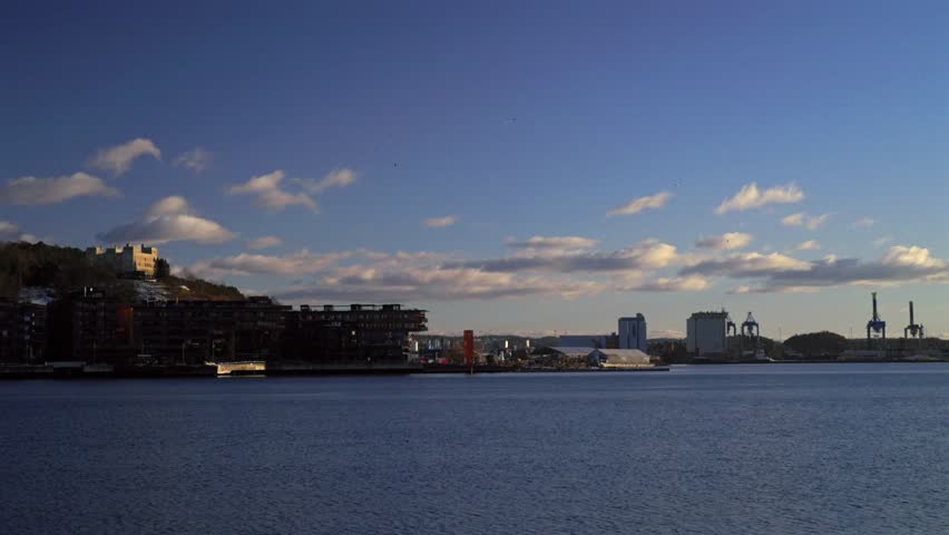 OsloFjord winter afternoon sunset day Oslo Norway Norge Oslo Opera House sea fjord view Hovedøya island industrial industry cruise boat ships buildings marina clouds clear blue skies static shot