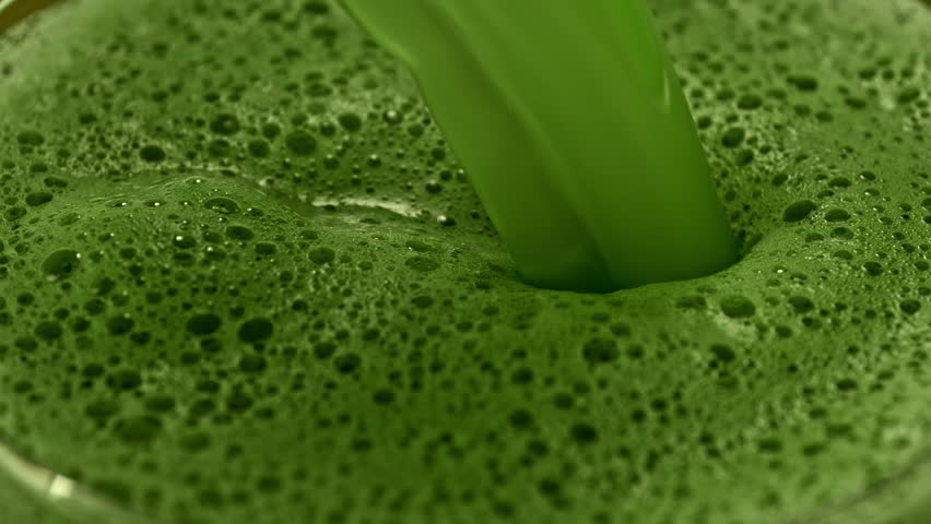 Super Slow Motion Detail Shot of Pouring Green Matcha Drink with Camera Motion at 1000fps.