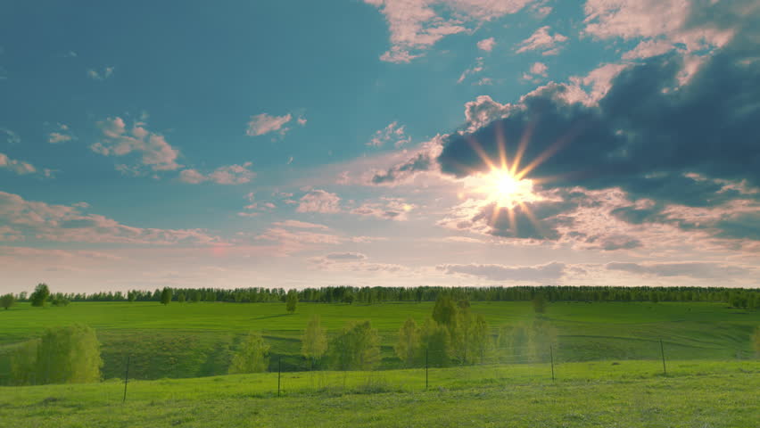 A serene and picturesque landscape showcasing the beauty of the sun and soft clouds Time lapse.