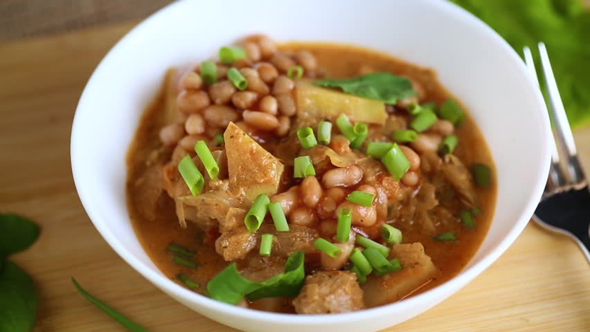 Vegetable stew with meat and potatoes in a white bowl on the table