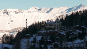 Drone aerial of Chandolin, Switzerland. Traditional alpine village with wooden chalets, snowy slopes and mountain peaks. Perfect winter tourism, travel and cinematic stock footage. - Powered by Shutterstock - Get 15% off with code: PIKWIZARD15