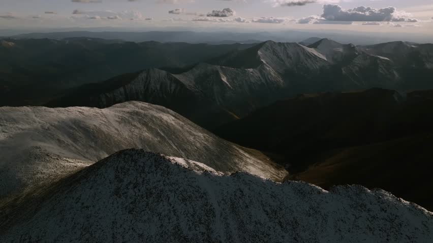 Top of summit snow dusted covered Mt Mount Shavano Taeguache Huron Peak aerial drone Colorado golden hour Rocky Mountains Mt Elbert Sawatch Range above treeline fall autumn parallax circle right