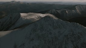 Sunset top of summit snow dusted covered Mt Mount Shavano Tabeguache Huron Peak aerial drone Colorado golden hour Rocky Mountains Mt Elbert Sawatch Range above treeline fall autumn forward pan up - Powered by Shutterstock - Get 15% off with code: PIKWIZARD15