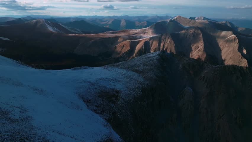 Sunset top of summit snow dusted covered Mt Mount Shavano Tabeguache Huron Peak aerial drone Colorado golden hour Rocky Mountains Mt Elbert Sawatch Range above treeline fall autumn forward pan up