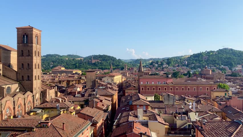 Bologna, Italy. View of the old town from above. Rooftops and streets, hills in the background.