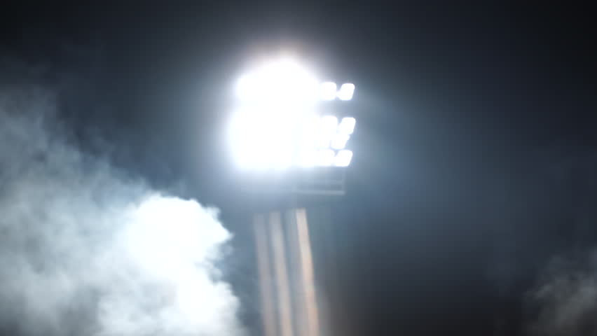 Football stadium floodlights, soccer field lights at night, bright stadium lighting, outdoor sports arena illumination, tall floodlight towers, shining lights over football pitch, stadium lights again